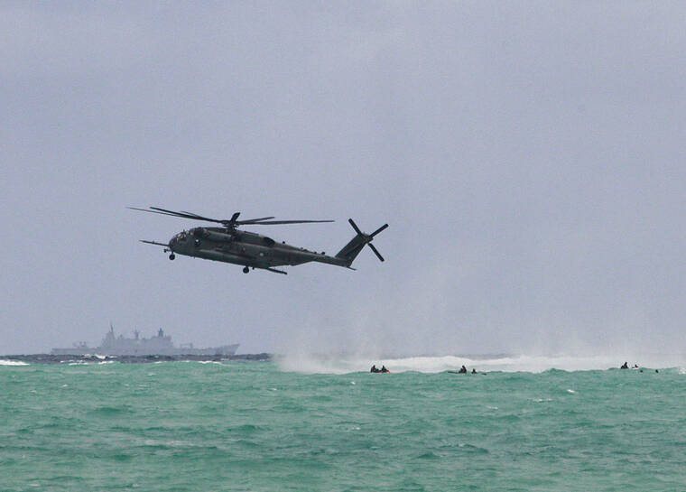 JAMM AQUINO / JAQUINO@STARADVERTISER.COM
                                Military personnel from Tonga, Sri Lanka, Malaysia, Australia and the United States participated Monday in Rim of the Pacific joint training exercises in Waimanalo. Above, a USMC CH-53 helicopter performed a drop into the ocean during RIMPAC’s urban close combat and jungle training at Bellows Air Force Station.