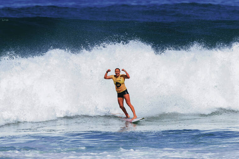 DANIEL SMORIGO / WORLD SURF LEAGUE
                                Five-time WSL Champion Carissa Moore flexed as she approached the shore after claiming the Oi Rio Pro crown on June 28 at Saquarema, Rio de Janeiro, Brazil.