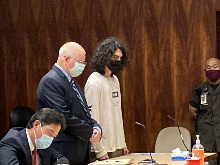 LEILA FUJIMORI / LFUJIMORI@STARADVERTISER.COM Erik Willis, 19, in a white T-shirt, stands with his attorney, Eric Seitz, as Circuit Judge Kevin Souza sentences him this morning to life in prison with the possibility of parole.