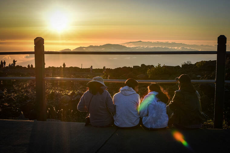 NATIONAL PARK SERVICE
                                Above, people watch the sunset at the Haleakala Visitor Center. ^