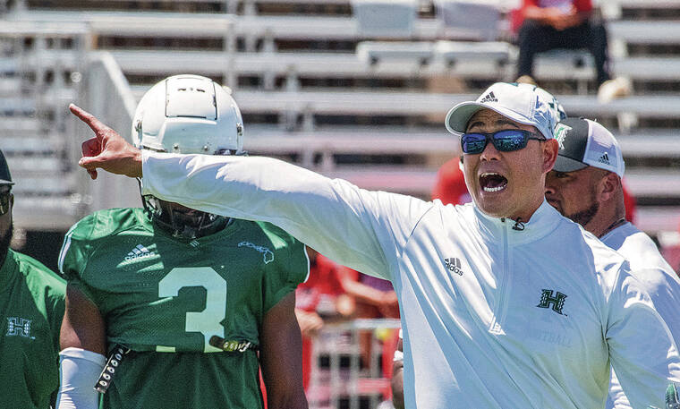 CRAIG T. KOJIMA / CKOJIMA@ STARADVERTISER.COM
                                University of Hawaii football coach Timmy Chang directed practice on campus on March 26. Chang and the coaching staff devised a split practice schedule for the first two weeks of fall camp, starting with two sessions this morning.