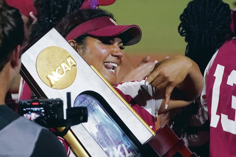 ASSOCIATED PRESS
                                The Sooners slugger held the NCAA trophy in 2022 as she did the year before.