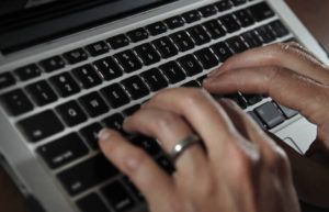 ASSOCIATED PRESS
                                A person types on a laptop keyboard in North Andover, Mass.