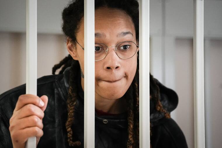 ASSOCIATED PRESS
                                WNBA star and two-time Olympic gold medalist Brittney Griner speaks to her lawyers while standing in a cage in a courtroom prior to a hearing, in Khimki just outside Moscow, Russia, Tuesday. Griner returns Tuesday to a Russian courtroom for her drawn-out trial on drug charges that could bring her 10 years in prison if convicted.