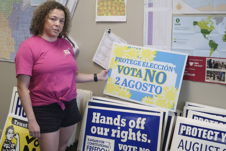 ASSOCIATED PRESS / JULY 15
                                Jessica Porter, communications chair for the Shawnee County, Kansas, Democratic Party, discusses a sign in Spanish urging voters to oppose a proposed amendment to the Kansas Constitution to allow legislators to further restrict or ban abortion, Friday, July 15, in Topeka, Kansas.