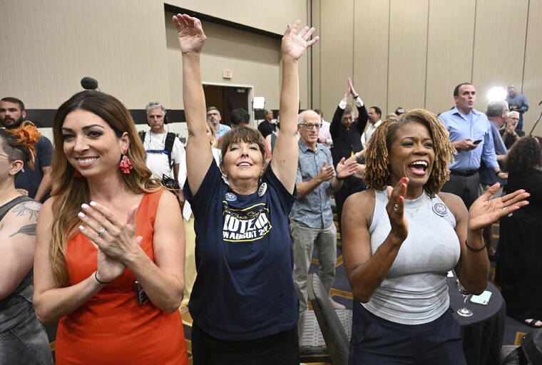 THE KANSAS CITY STAR VIA AP
                                Calley Malloy, left, of Shawnee, Kan.; Cassie Woolworth, of Olathe, Kan.; and Dawn Rattan, right, of Shawnee, Kan., applaud during a primary watch party in Overland Park, Kan.