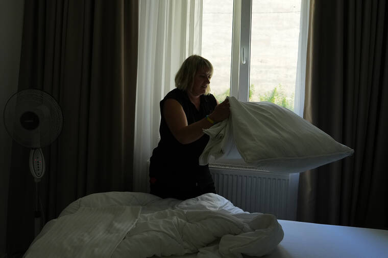 ASSOCIATED PRESS
                                Ukrainian refugee Liudmyla Chudyjovych makes up a room in a hotel where she works in Prague, Czech Republic.