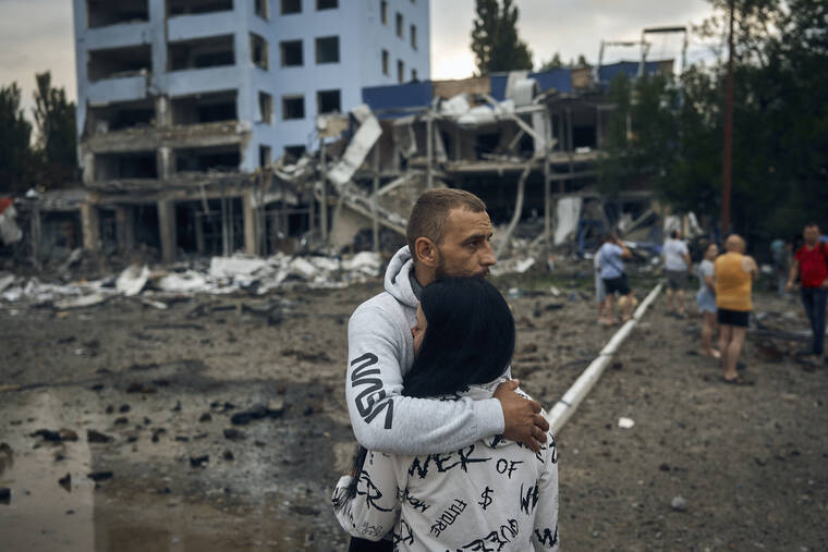 ASSOCIATED PRESS / AUG. 3
                                A couple reacts after the Russian shelling in Mykolaiv, Ukraine. According to local media, a supermarket, high-rise buildings and a pharmacy were damaged.