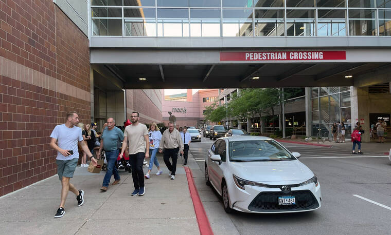 TRISHA AHMED / AP
                                Customers leave the Mall of America after a lockdown was lifted in a shooting, where police have said no victim was found and a suspect has fled, Thursday, Aug. 4, in Bloomington, Minn.