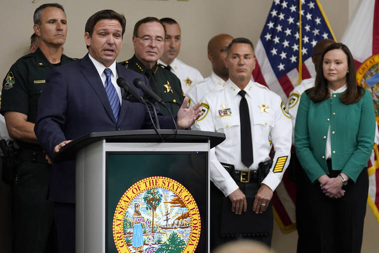 ASSOCIATED PRESS
                                Florida Gov. Ron DeSantis, surrounded by members of law enforcement, gestures as he speaks during a news conference, Thursday, in Tampa, Fla. DeSantis announced that he was suspending State Attorney Andrew Warren, of the 13th Judicial Circuit, due to “neglect of duty.” Looking on at right is Florida Attorney General Ashley Moody.