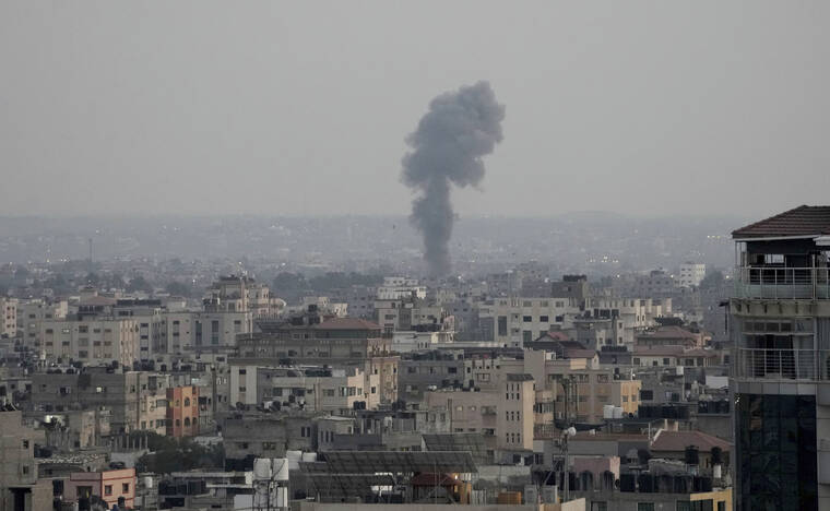HATEM MOUSSA / AP
                                Smoke rises following Israeli airstrikes on a building in Gaza City, Friday. Palestinian officials say Israeli airstrikes on Gaza have killed several people, including a senior militant, and wounded 40 others.