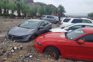 NATIONAL PARK SERVICE / AP
                                In this photo provided by the National Park Service, cars are stuck in mud and debris from flash flooding at The Inn at Death Valley in Death Valley National Park, Calif., Friday, Aug. 5.