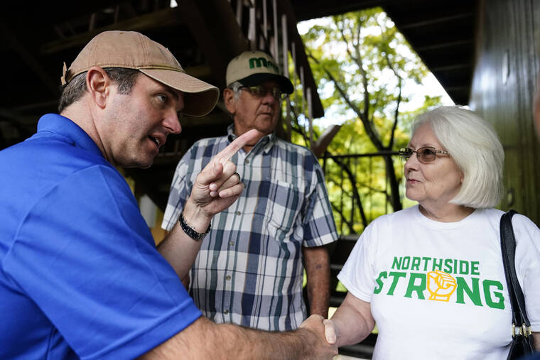 ASSOCIATED PRESS / AUG. 6
                                Kentucky Governor Andy Beshear, center, talks with residents that have been displaced by floodwaters at Jenny Wiley State Resort Park in Prestonsburg, Ky.
