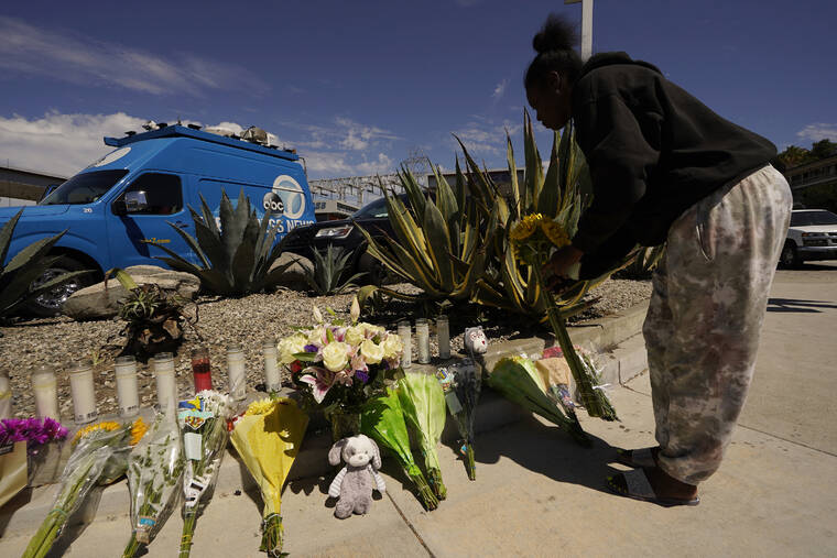 ASSOCIATED PRESS / AUG. 5
                                Neighbor Mary Thompson prays as she brings a bouquet to the memorial site set after a crash involving as many as six cars near a gas station in the unincorporated Windsor Hills in Los Angeles. Authorities said that a speeding car ran a red light and plowed into cars in a crowded intersection Thursday in a fiery crash that killed several people, including a baby.