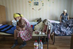 ASSOCIATED PRESS
                                Vera Vasiukova, 71, left, sits on her bed at a center for displaced people near Mykolaiv, Ukraine, Tuesday. Vera’s house was destroyed by Russian attacks in Snigurivka village, Mykolaiv region.