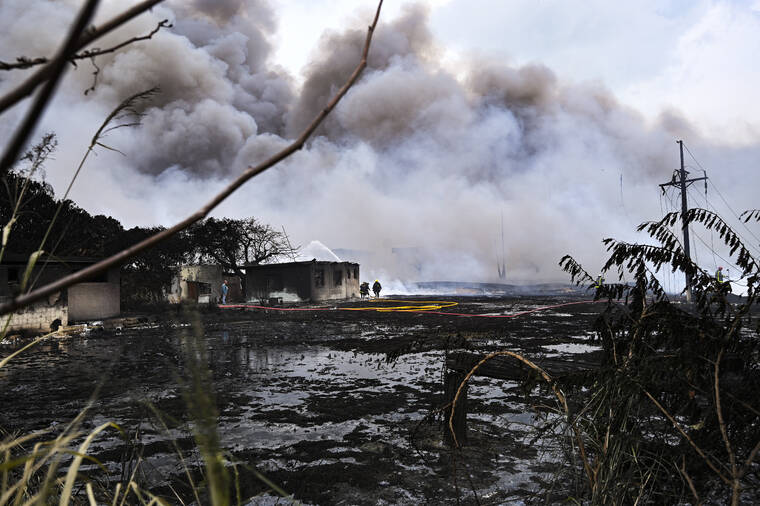 POOL PHOTO / AP
                                Smoke continues to billow from a days-long, deadly fire at a large oil storage facility in Matanzas, Cuba, Tuesday, Aug. 9. The fire was triggered by lighting at one of the facility’s eight tanks late Friday, Aug. 5th.