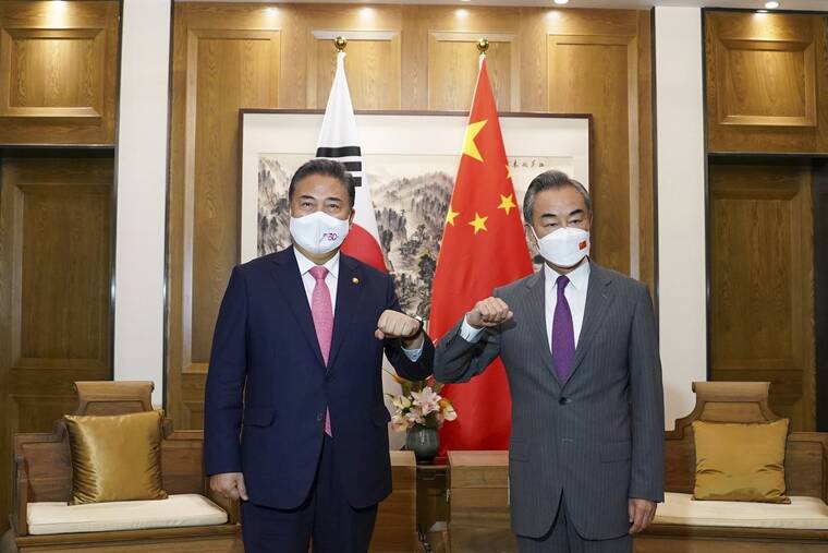 SOUTH KOREA FOREIGN MINISTRY / AP
                                In this photo provided by South Korea Foreign Ministry, South Korean Foreign Minister Park Jin, left, bumps elbows with his Chinese counterpart Wang Yi prior to their meeting in Qingdao, China, Tuesday, Aug. 9.