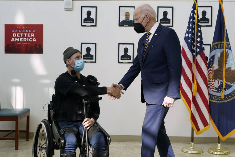 ASSOCIATED PRESS
                                President Joe Biden shakes hands with veteran John Caruso as Biden tour’s the Fort Worth VA Clinic in Fort Worth, Texas, March 8. Biden, whose elder son Beau died of cancer years after deploying to Iraq, signed legislation today expanding federal health care services for millions of veterans who served at military bases where toxic smoke billowed from huge “burn pits.”