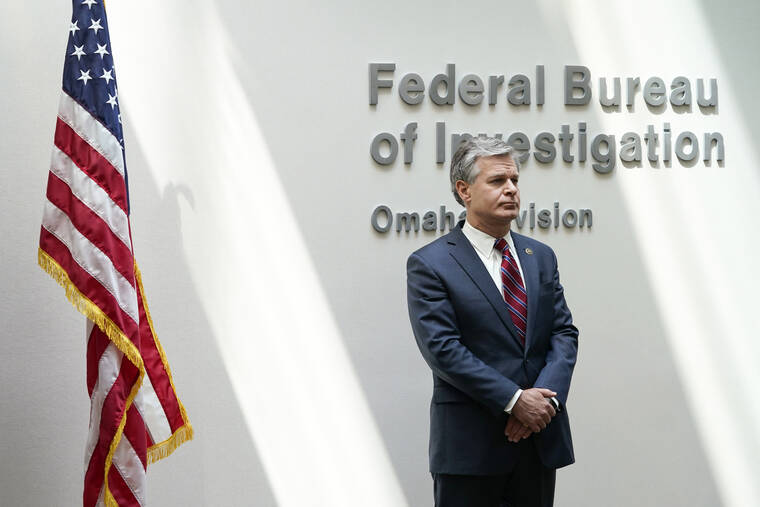 CHARLIE NEIBERGALL / AP
                                FBI Director Christopher Wray waits to speak at a news conference, Wednesday, Aug. 10, in Omaha, Neb.