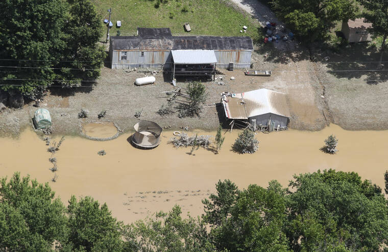 COURIER JOURNAL / AP / JULY 30
                                In this aerial photo, some homes in Breathitt County, Ky., are still surrounded by water Saturday, July 30, after historic rains flooded many areas of Eastern Kentucky killing multiple people.