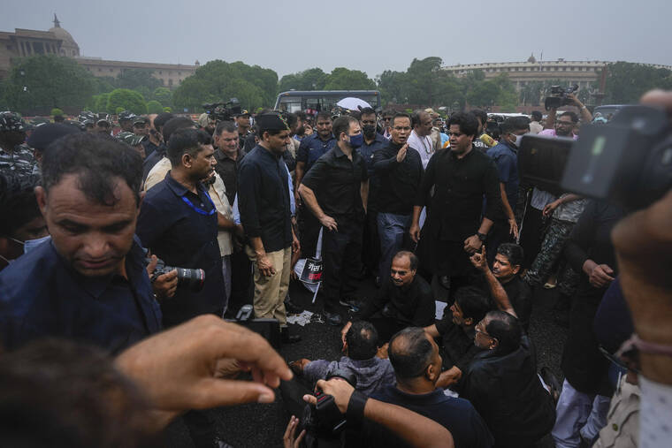 ASSOCIATED PRESS
                                Congress party leader Rahul Gandhi, center in blue mask, and other lawmakers participate in a protest in New Delhi, India, on Aug. 5.