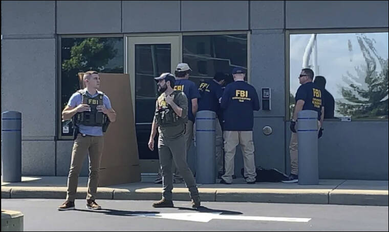 FOX19 CINCINNATI VIA ASSOCIATED PRESS
                                FBI officials gather outside the FBI building in Cincinnati, Thursday. An armed man decked out in body armor tried to breach a security screening area at the FBI field office in Ohio on Thursday, then fled and exchanged gunfire in a standoff with law enforcement, authorities said.