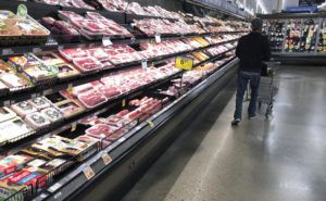 ASSOCIATED PRESS
                                A shopper pushes his cart past a display of packaged meat, in May 2020, in a grocery store in southeast Denver. Prices at the wholesale level fell from June to July, the first month-to-month drop in more than two years and a sign that some of the U.S. economy’s inflationary pressures cooled last month.