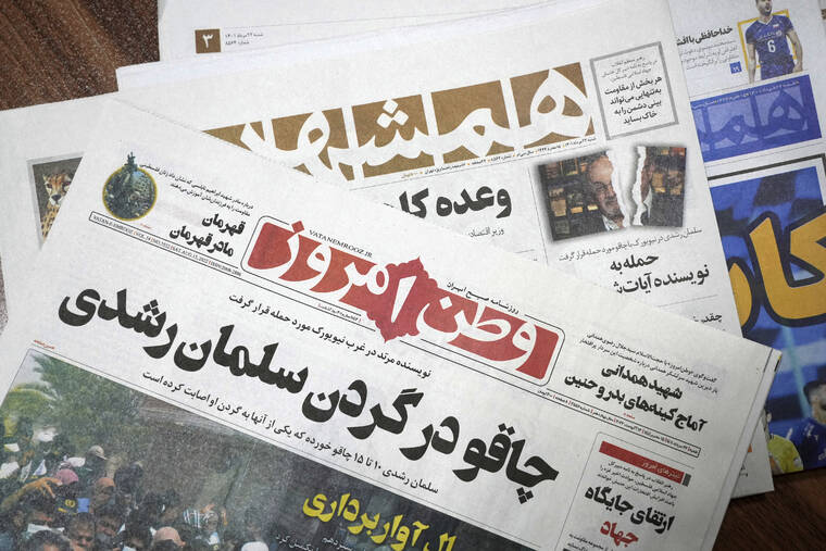 ASSOCIATED PRESS
                                The front pages of the Aug. 13 edition of the Iranian newspapers, Vatan-e Emrooz, front, with title reading in Farsi: “Knife in the neck of Salman Rushdie,” and Hamshahri, rear, with title: “Attack on writer of Satanic Verses,” are pictured in Tehran today.