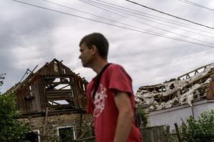 DAVID GOLDMAN / AP
                                A pedestrian passes damaged homes Saturday, Aug. 13, from a Russian rocket attack last night in Kramatorsk, Donetsk region, eastern Ukraine. The strike killed three people and wounded 13 others, according to the mayor.