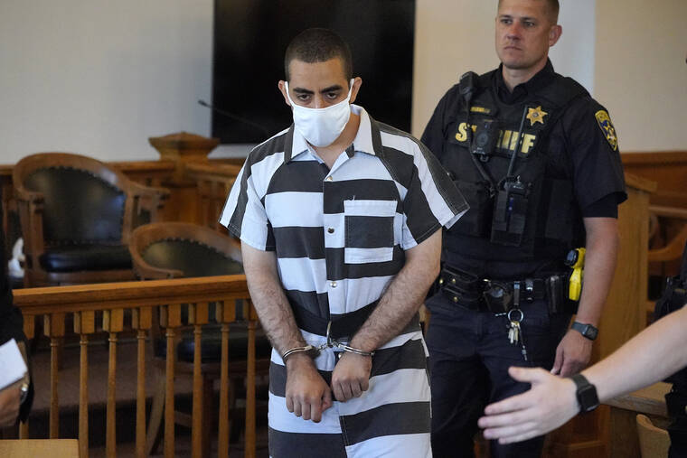 ASSOCIATED PRESS
                                Hadi Matar, 24, center, arrives for an arraignment in the Chautauqua County Courthouse in Mayville, N.Y., Saturday, Aug. 13, 2022. Matar, who is accused of carrying out a stabbing attack against “Satanic Verses” author Salman Rushdie has entered a not-guilty plea in a New York court on charges of attempted murder and assault. An attorney for Matar entered the plea on his behalf during an arraignment hearing.