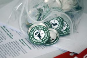 ASSOCIATED PRESS
                                Pro-union pins sit on a table during a watch party for Starbucks’ employees’ union election, Dec. 9, 2021, in Buffalo, N.Y. Starbucks is asking the National Labor Relations Board to temporarily suspend all union elections at its U.S. stores in response to allegations of improper coordination between regional NLRB officials and the union.