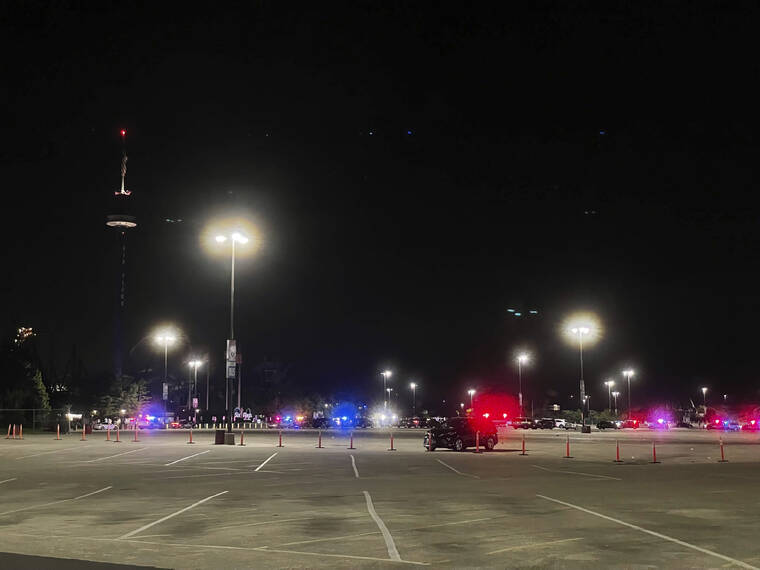 KAITLIN WASHBURN/CHICAGO SUN-TIMES VIA ASSOCIATED PRESS
                                Emergency vehicles are shown in the parking lot of Six Flags Great America in Gurnee, Ill., Sunday night. Three people were injured in a shooting in the parking lot that sent visitors scrambling for safety, authorities said.