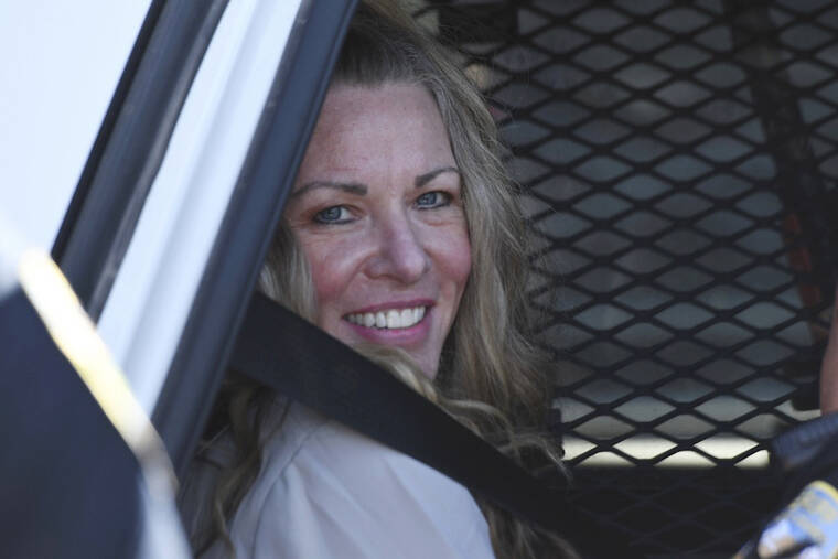 EAST IDAHO NEWS/TONY BLAKESLEE/EAST IDAHO NEWS VIA AP, POOL
                                Lori Vallow Daybell sits in a police car after a hearing at the Fremont County Courthouse in St. Anthony, Idaho. Attorneys for a mom charged with conspiring to kill her children and then steal their social security benefits asked a judge on Tuesday to send the case back to a grand jury because they say the current indictment is confusing. Lori Vallow Daybell and her husband Chad Daybell have pleaded not guilty and could face the death penalty if convicted.