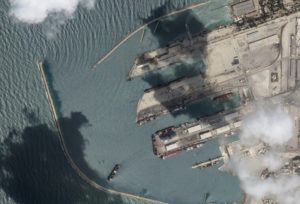 PLANET LABS / AP / AUG. 15
                                This satellite image from Planet Labs PBC shows the Sierra Leone-flagged cargo ship Razoni, center bottom with four white cranes on its red deck, at port in Tartus, Syria, Monday.