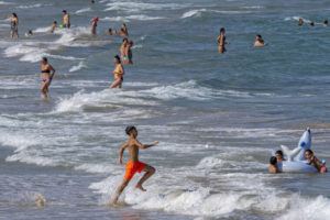 ASSOCIATED PRESS
                                People cool off on Puerto de Sagunto beach in Spain.