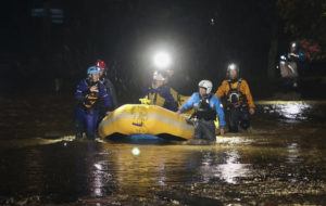 NEW ZEALAND HERALD VIA AP
                                Emergency workers use an inflatable boat to rescue stranded residents in Nelson, New Zealand.