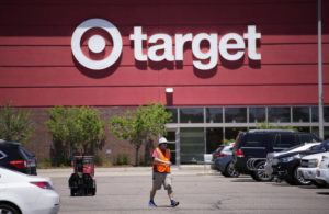 ASSOCIATED PRESS
                                A worker collects shopping carts in the parking lot of a Target store, in June 2021, in Highlands Ranch, Colo. Target reported solid sales for the fiscal second quarter of 2022, but its profits plunged nearly 90% because it slashed prices to clear inventories of clothing, home goods and other discretionary items.
