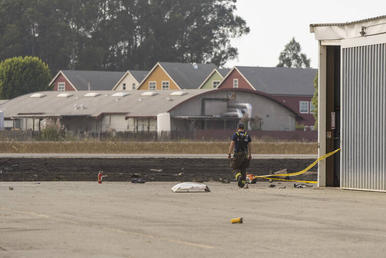 NIC COURY / AP
                                A firefighter walks by wreckage from a plane crash at Watsonville Municipal Airport in Watsonville, Calif., Thursday, Aug. 18.