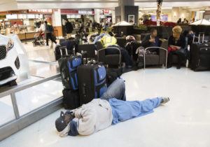 ASSOCIATED PRESS
                                A man sleeps on the terminal floor at Hartfield-Jackson Atlanta International Airport in December 2017, in Atlanta. Transportation Secretary Pete Buttigieg has warned airlines that his department could draft new rules around passenger rights if the carriers don’t give more help to travelers trapped by flight cancellations and delays.