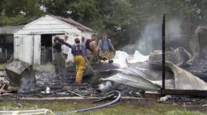 KFVS TV / AP
                                This photo from video by KFVS-TV shows people working the scene of a house explosion in Wyatt Mo., early Monday, Aug. 15.