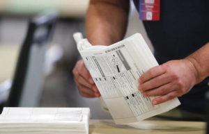 JAMM AQUINO/JAQUINO@STARADVERTISER.COM
                                Ballots are prepped before being tallied on a machine during the general election at the Hawaii Convention Center in Honolulu, Hawaii.