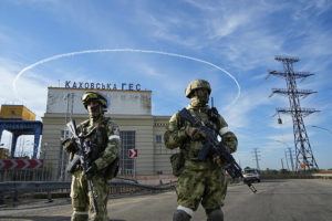 ASSOCIATED PRESS / MAY 20
                                Russian troops guard an entrance of the Kakhovka Hydroelectric Station, a run-of-the-river power plant on the Dnieper River in Kherson region, southern Ukraine.