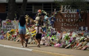 ASSOCIATED PRESS
                                Visitors walk past a makeshift memorial honoring those killed at Robb Elementary School on July 12 in Uvalde, Texas.