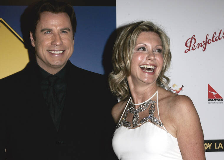 ASSOCIATED PRESS / 2006
                                John Travolta, left, and Olivia Newton-John arrive at the The Penfolds Icon Gala Dinner in Los Angeles. Travolta, who starred with Newton-John in “Grease,” presented Newton-John with the “Lifetime Achievement award. Newton-John, a longtime resident of Australia whose sales topped 100 million albums, died Monday at her southern California ranch, John Easterling, her husband, wrote on Instagram and Facebook. She was 73.