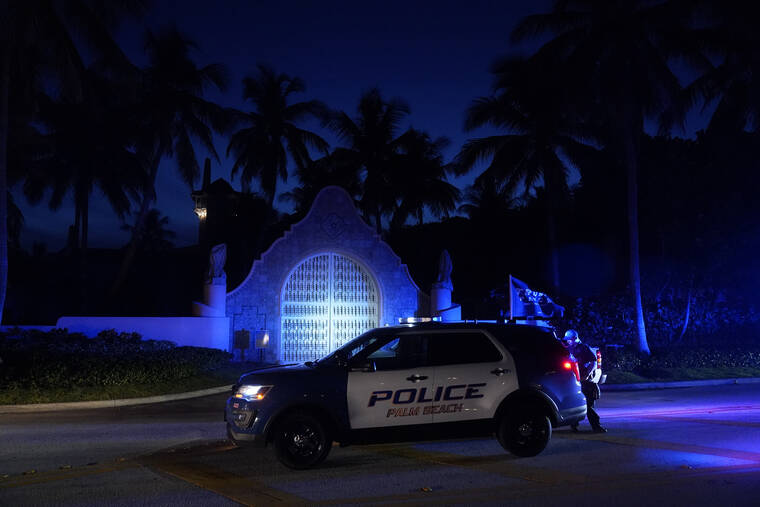 ASSOCIATED PRESS
                                Police stand outside an entrance to former President Donald Trump’s Mar-a-Lago estate in Palm Beach, Fla. Trump said in a lengthy statement that the FBI was conducting a search of his Mar-a-Lago estate and asserted that agents had broken open a safe.