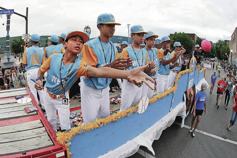ASSOCIATED PRESS
                                Luke Hiromoto tossed back an autographed soft baseball as the West Region champion from Honolulu rode in the Little League Grand Slam Parade in downtown Williamsport, Pa., on Monday. The Little League World Series, featuring 20 teams from around the world, starts Wednesday. Honolulu opens against the Northwest Region champion from the state of Washington.