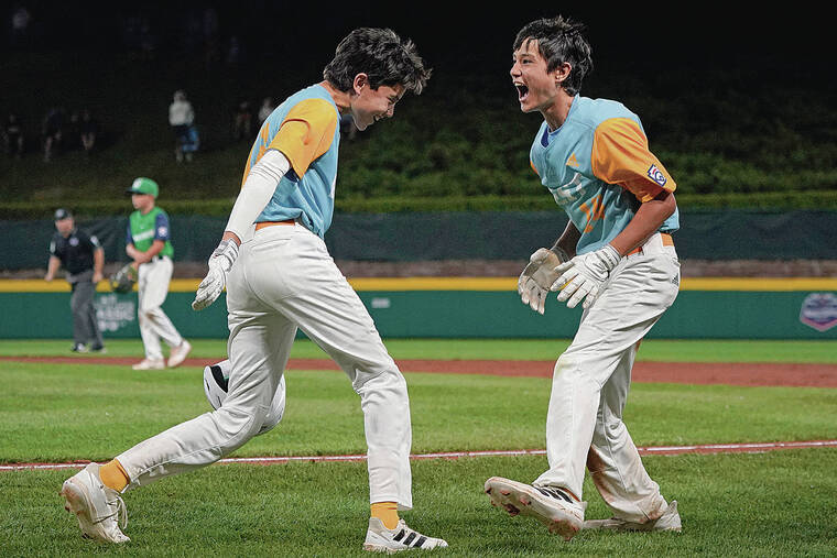 ASSOCIATED PRESS
                                Honolulu’s Rustan Hiyoto, left, and Kama Angell celebrated a score during the fifth inning on Wednesday.