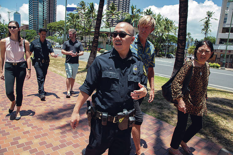 KAT WADE / SPECIAL TO THE STAR-ADVERTISER
                                At top, state Sen. Sharon Moriwaki, right, talks with HPD officer Ryan Yamamoto and John Deutzman while state House candidate Jillian Anderson, left, officer Moses Chang-Nuusolia and Waikiki resident Chad Snater follow behind.