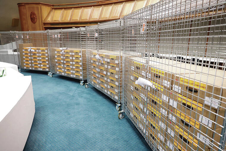 JAMM AQUINO / JAQUINO@STARADVERTISER.COM 
                                Despite voter turnout, many volunteers have been forced to go home early due to the lack of ballots to count. Cages containing counted ballots sat Thursday on the Senate floor at the state Capitol.