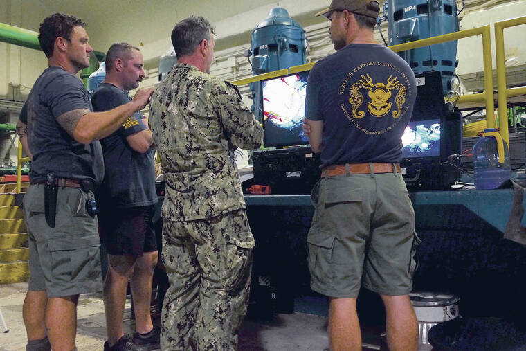 KEVIN KNODELL / KKNODELL@STARADVERTISER.COM
                                Members of Mobile Diving and Salvage Unit One watched a live feed of the mission from the Red Hill well pump room on Dec. 12. The unit worked in the well from December through February.